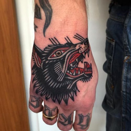 Traditional wolf tattoo on hand