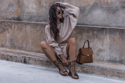 stylish woman with boots and hand bag